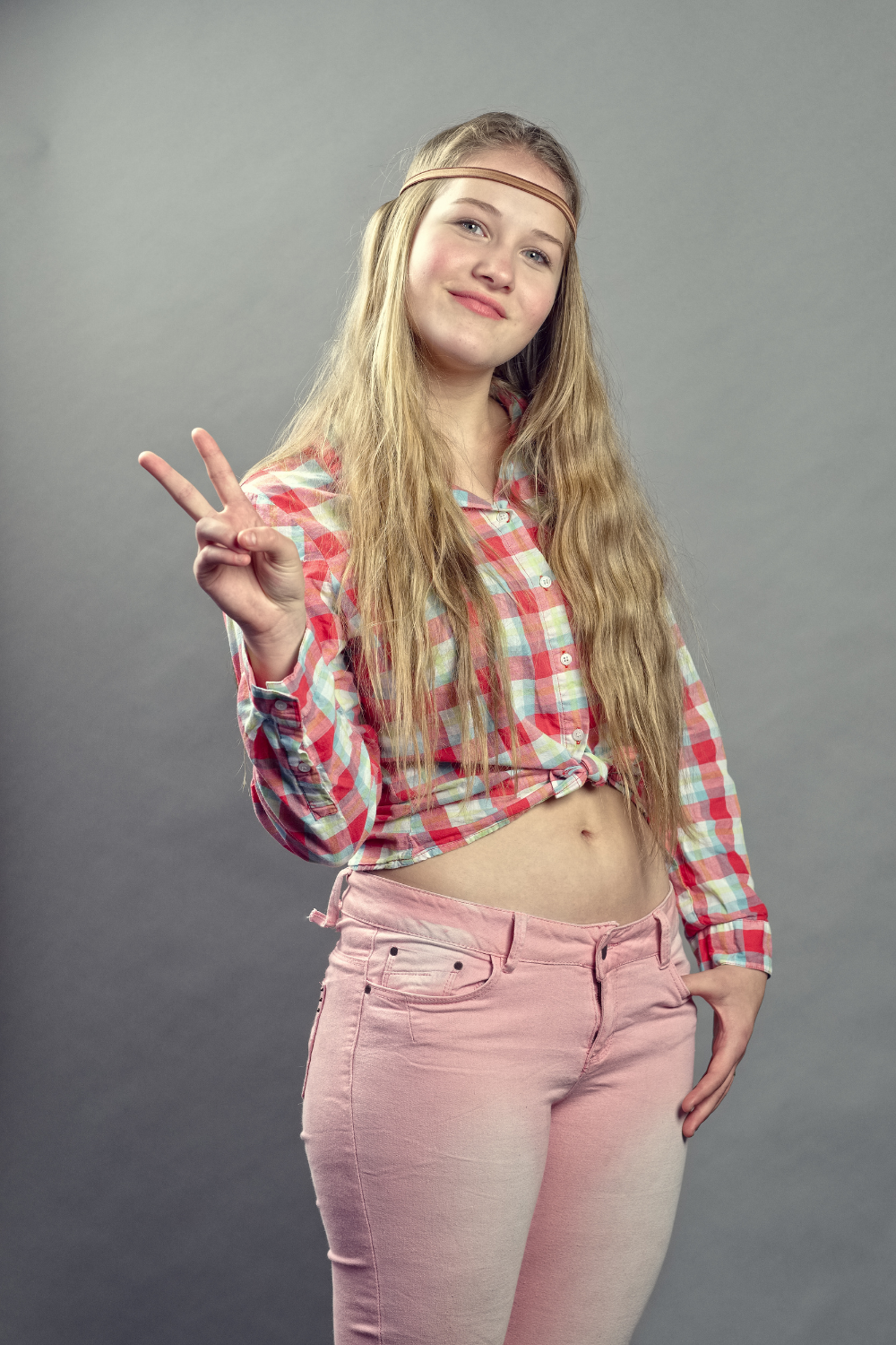 1960s hippie costume style: long straight hair, bell bottoms and peace signs