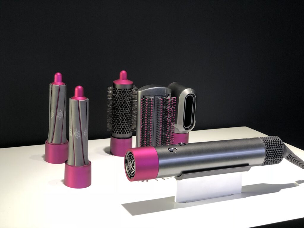 The newly-released Dyson Airwrap Styler is on display at the press conference in Beijing, China, 18 October 2018. Dyson has released a hair styling tool that uses the efficient speed of its vacuum motors to change your look in Beijing on Thursday (18 October 2018). The company ¨C better known for its vacuums, and with all eyes on a car it is making ¨C has made its second move into the beauty industry, following the success of the ¡ê300 Supersonic hair dryer. The Dyson Airwrap costs ¡ê400 and is on sale now. It uses the motor that powers its vacuums to create jets of air that can then be used to style hair into curls, waves and smooth blow dries without the need for extreme heat.