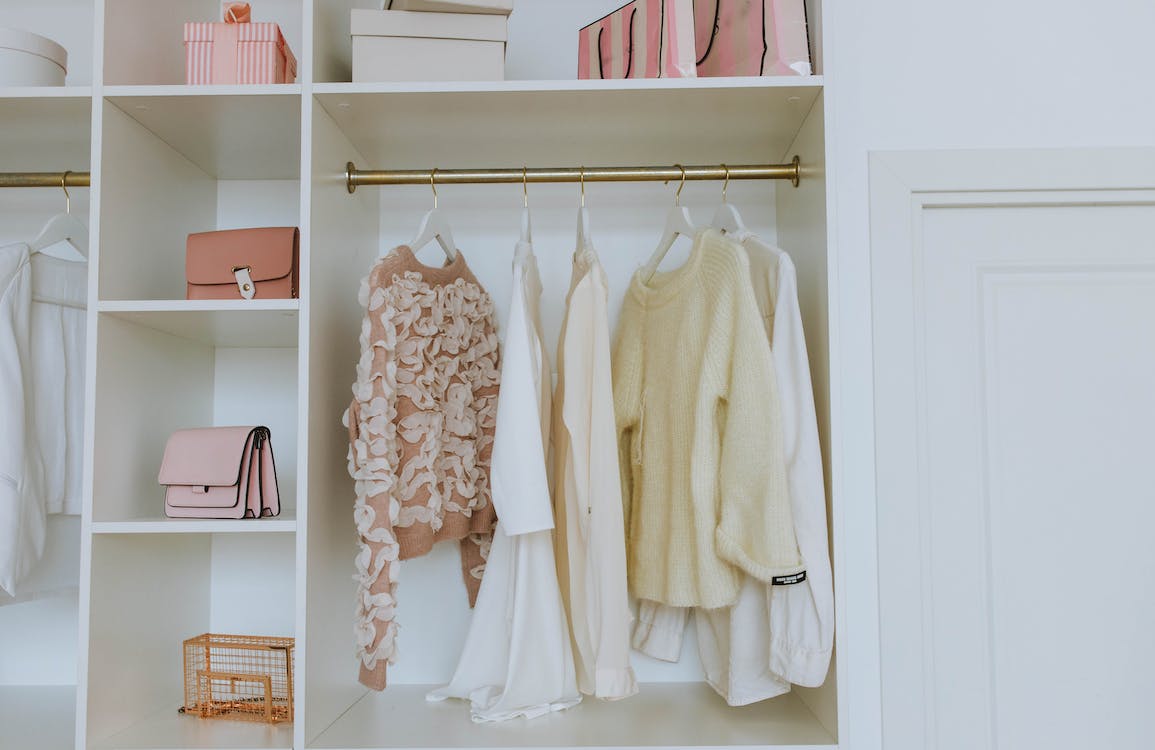 A capsule wardrobe with pink and white clothes.
