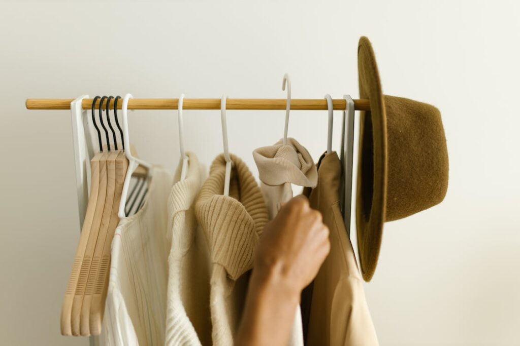 Hanging of clothes on a clothing rack.