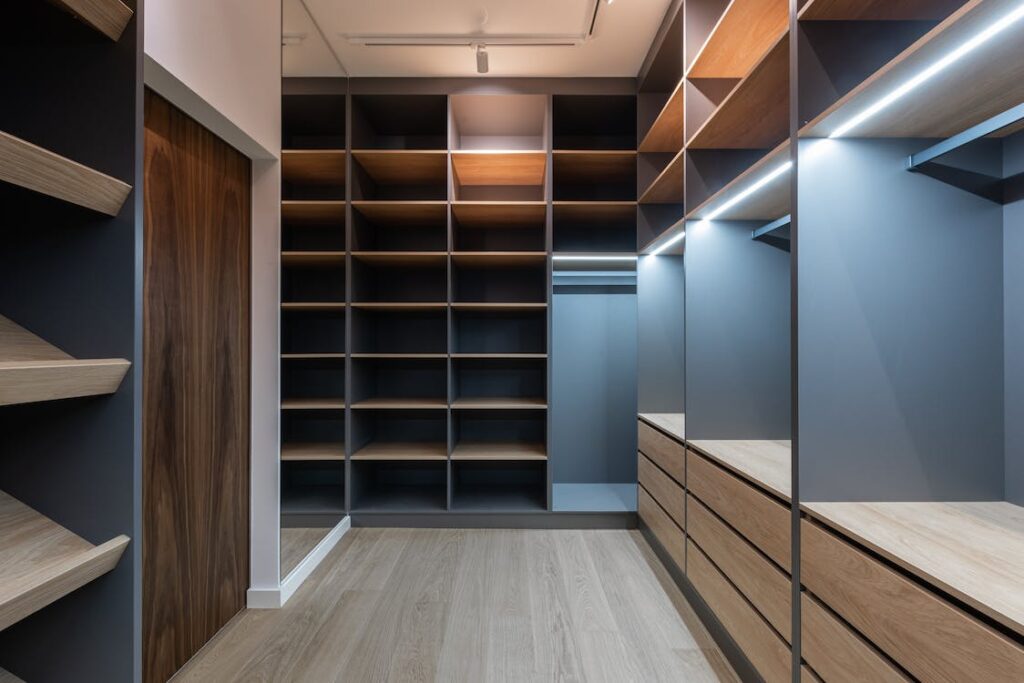 A large closet with grey and wooden accents, perfect examples for redesigning your wardrobe and your home. 