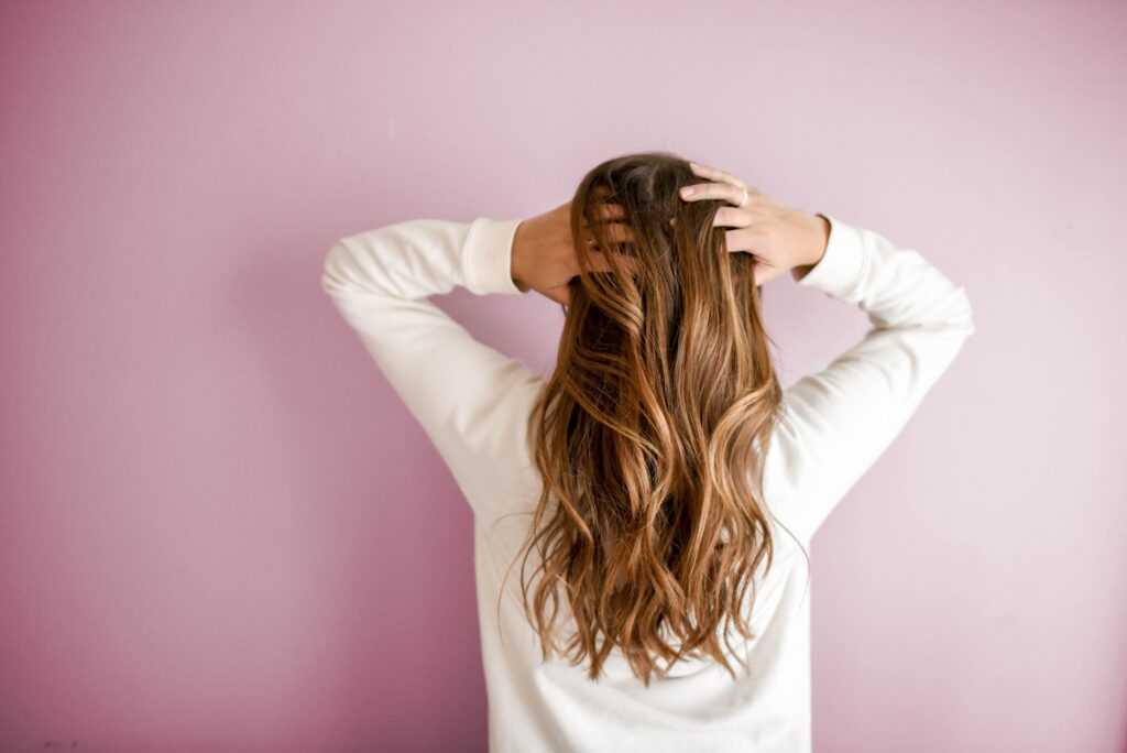 A woman touching her hair.