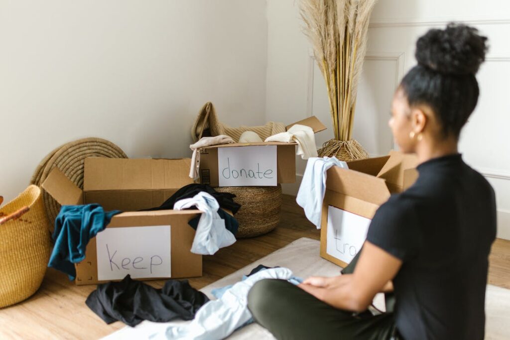 A woman decluttering and thinking about how to responsibly declutter your closet.