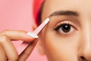 woman with pink hair using Baby Pink Eyebrow Tweezers